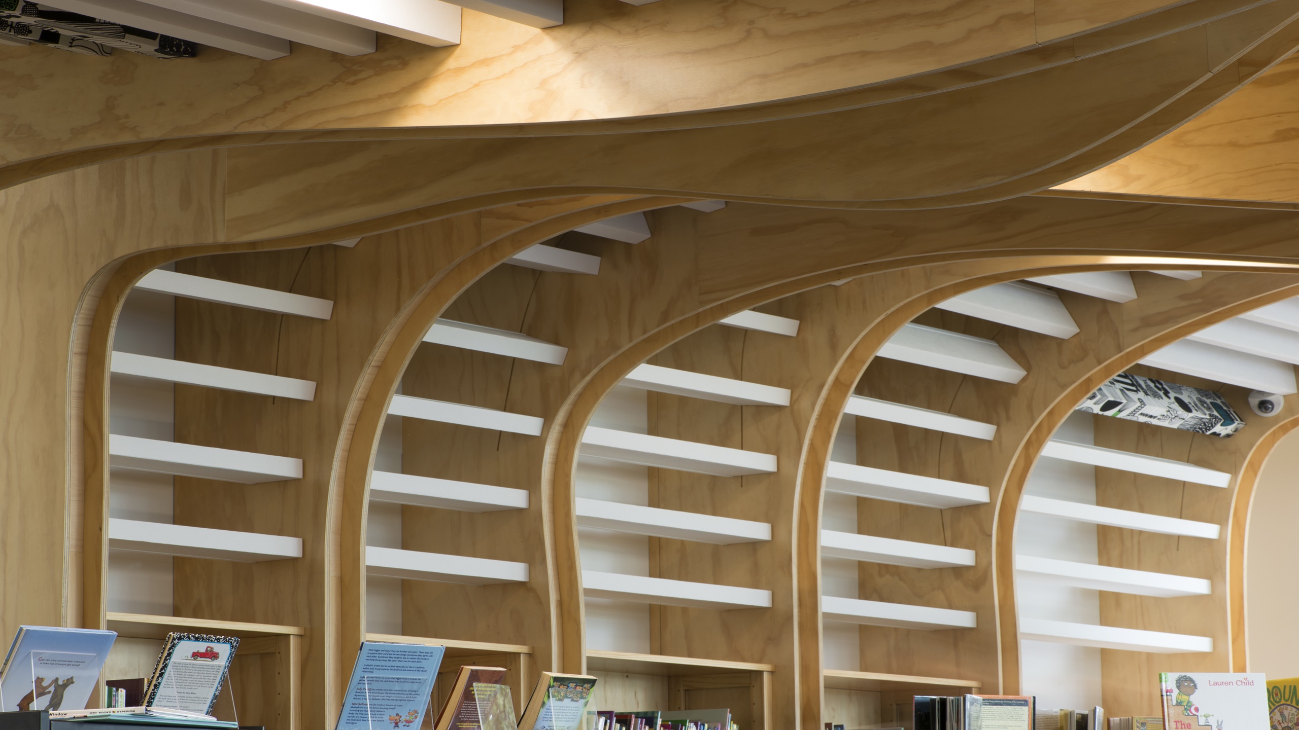 Devonport Library showing white baffle beams installed onto an undulating ceiling feature